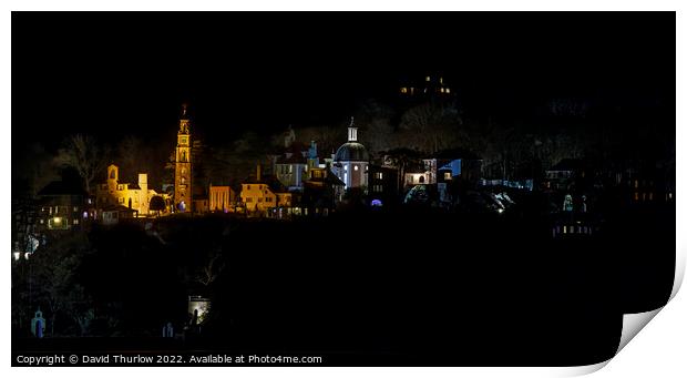 The lights of the Italianate village of Portmeirion illuminate the surrounding trees Print by David Thurlow