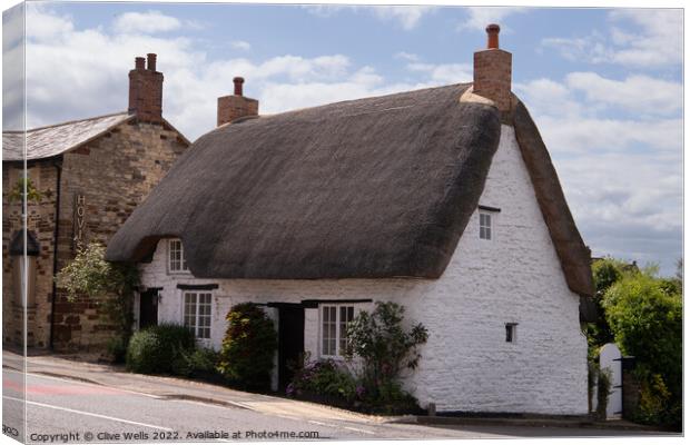 Whitewashed cottage Canvas Print by Clive Wells