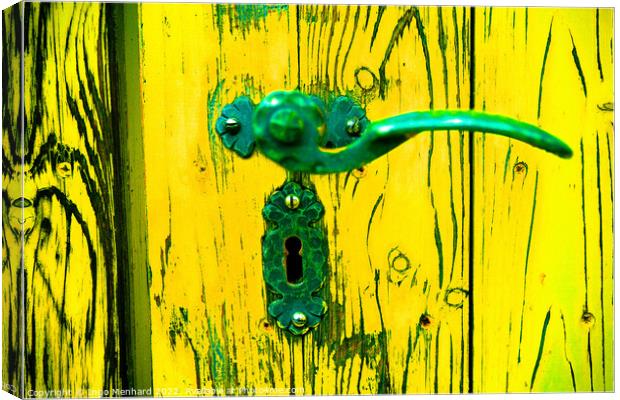 A closeup shot of an old metal handle and lock on the weathered yellow wooden door Canvas Print by Ingo Menhard