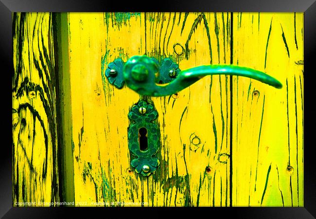 A closeup shot of an old metal handle and lock on the weathered yellow wooden door Framed Print by Ingo Menhard