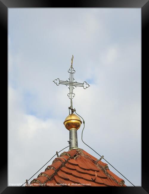 A vertical shot of a metallic cross on a cloudy sky background. Framed Print by Ingo Menhard