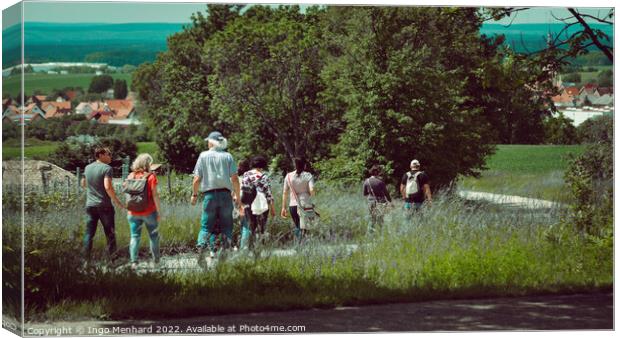Group of wanderers at the Friedrichsberg in Bavaria walking to the village of Abtswind Canvas Print by Ingo Menhard