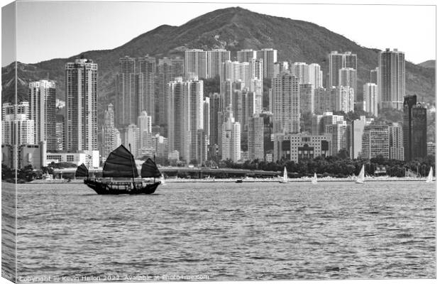 Junk sailing in Victoria Harbour, Hong Kong Canvas Print by Kevin Hellon