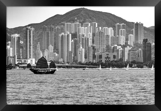 Junk sailing in Victoria Harbour, Hong Kong Framed Print by Kevin Hellon