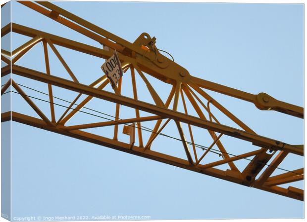 A low angle shot of a part of a construction crane against the clear blue sky Canvas Print by Ingo Menhard