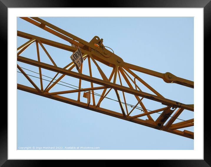 A low angle shot of a part of a construction crane against the clear blue sky Framed Mounted Print by Ingo Menhard