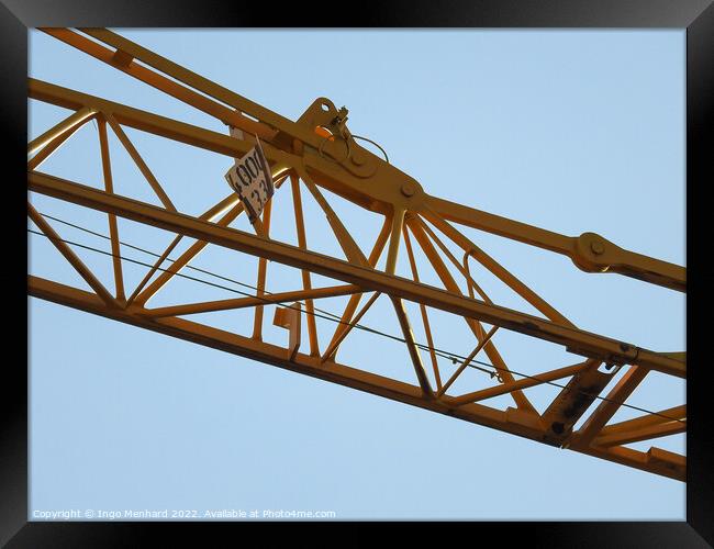 A low angle shot of a part of a construction crane against the clear blue sky Framed Print by Ingo Menhard