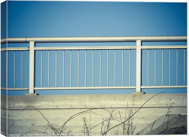 Closeup shot of iron porch railings on a blue sky background Canvas Print by Ingo Menhard