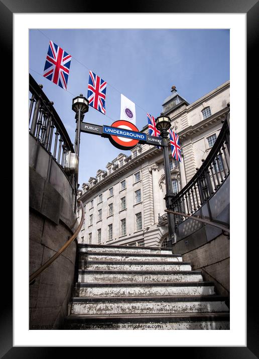 Bunting for the Queen`s Platinum Jubilee seen above Piccadilly  underground station in London, taken 21st May 2022. Framed Mounted Print by Clive Wells