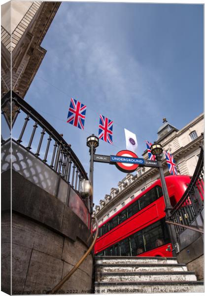 Bunting above the tube station with London bus. Canvas Print by Clive Wells