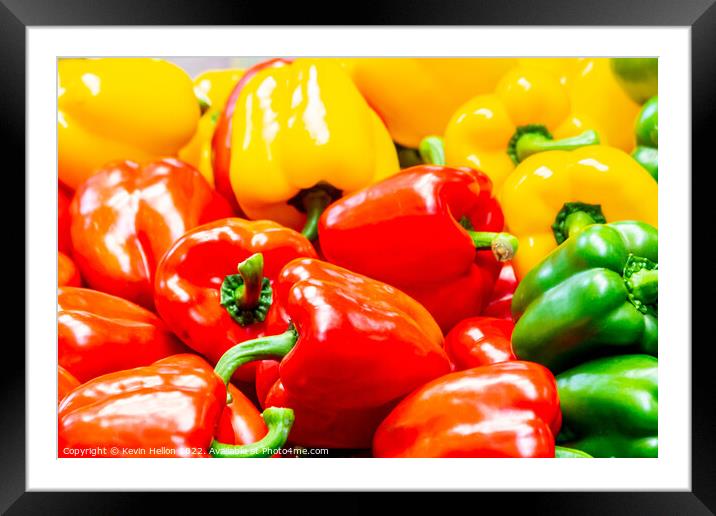 Red, yellow and green peppers on a market stall Framed Mounted Print by Kevin Hellon