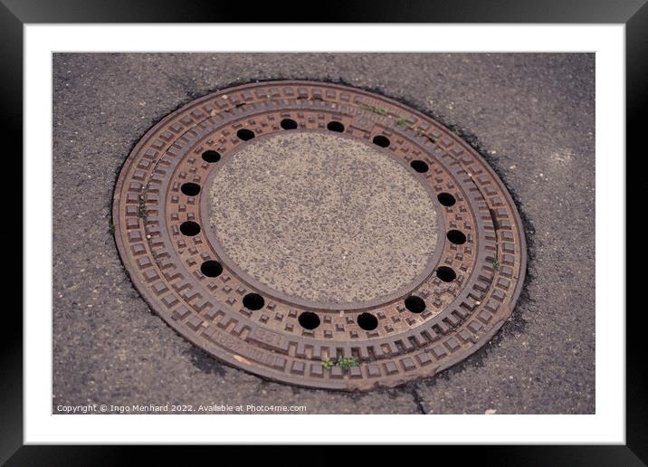 Closeup shot of sewer hatch Framed Mounted Print by Ingo Menhard