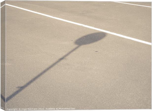 A road with white line-markings and a sign shadow Canvas Print by Ingo Menhard