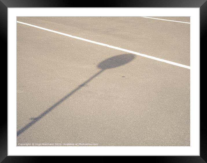 A road with white line-markings and a sign shadow Framed Mounted Print by Ingo Menhard