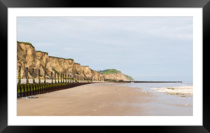 Sea defences at West Runton curve round the coast Framed Mounted Print by Jason Wells