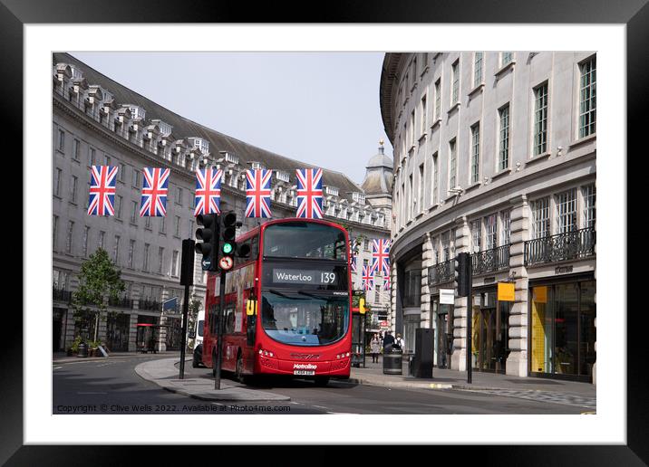 London bus under the flags Framed Mounted Print by Clive Wells