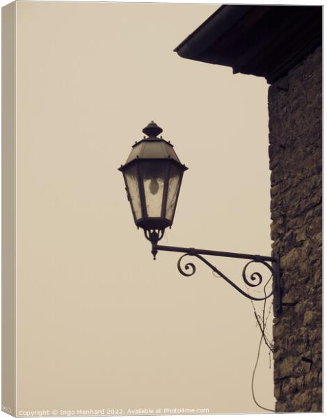 Closeup of a vintage wall-mounted lantern in the light background Canvas Print by Ingo Menhard