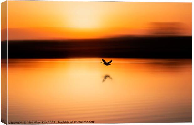 bird flying over a lake in an orange sunrise Canvas Print by TheOther Kev