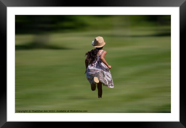 Child in vintage dress and hat running on grass Framed Mounted Print by TheOther Kev
