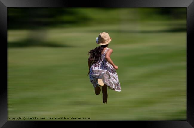 Child in vintage dress and hat running on grass Framed Print by TheOther Kev