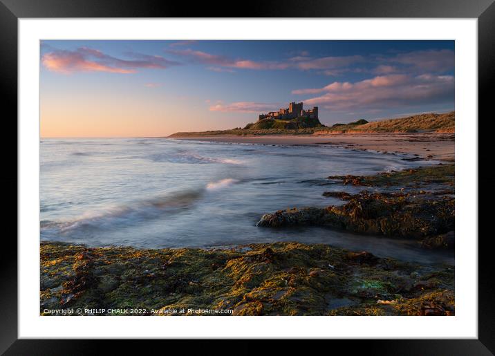 Sunrise glow over Bamburgh castle on the Northumbe Framed Mounted Print by PHILIP CHALK