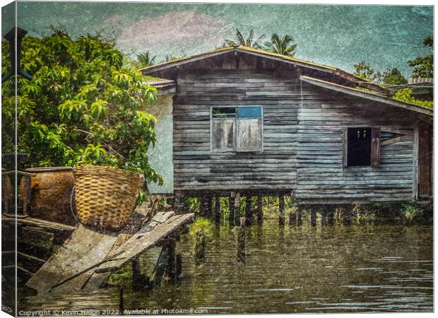 Old teak house on a canal in Thonburi, Bangkok, Thailand Canvas Print by Kevin Hellon
