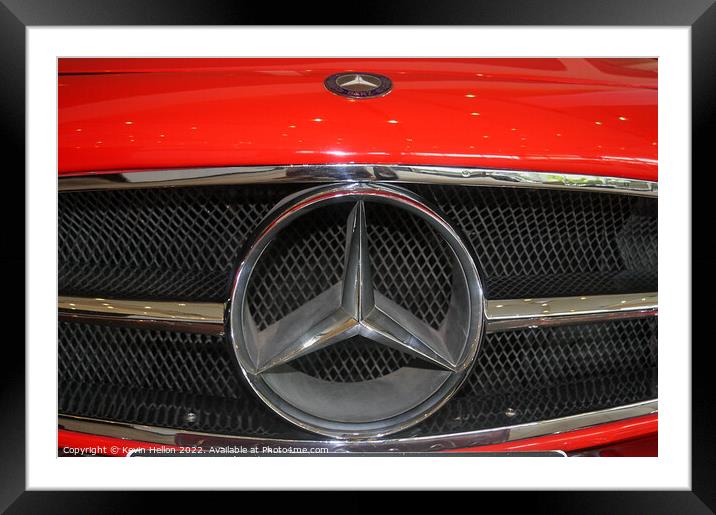 Mercedes badge on a red car. Framed Mounted Print by Kevin Hellon