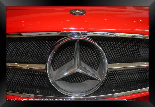 Mercedes badge on a red car. Framed Print by Kevin Hellon