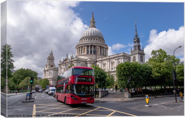 Red bus at St.Paul`s. Canvas Print by Clive Wells