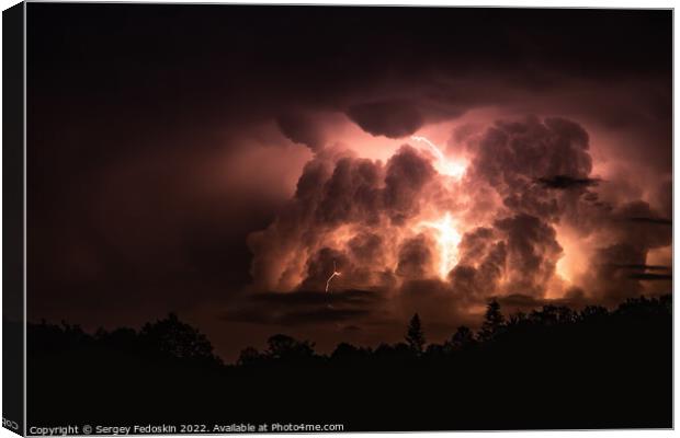 Lightning in the sky during a storm at night Canvas Print by Sergey Fedoskin