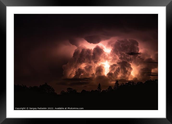 Lightning in the sky during a storm at night Framed Mounted Print by Sergey Fedoskin