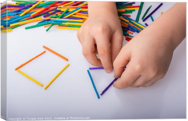 Kid making geometric shapes with colorful sticks o Canvas Print by Turgay Koca
