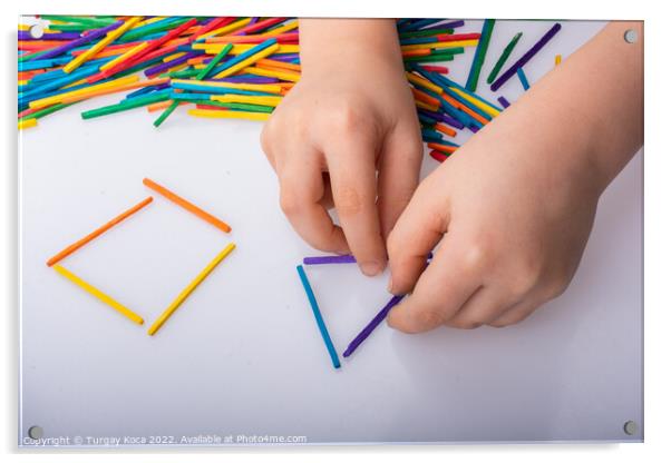 Kid making geometric shapes with colorful sticks o Acrylic by Turgay Koca