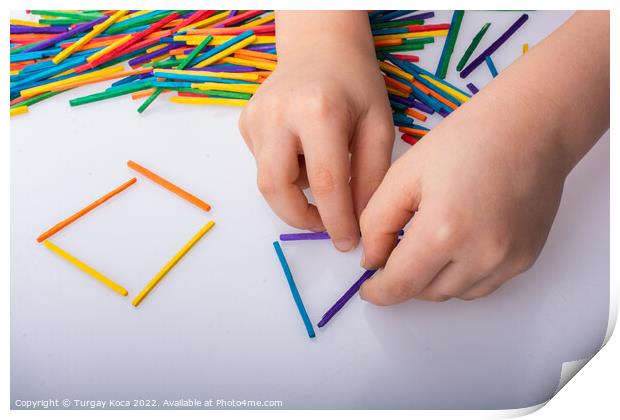 Kid making geometric shapes with colorful sticks o Print by Turgay Koca