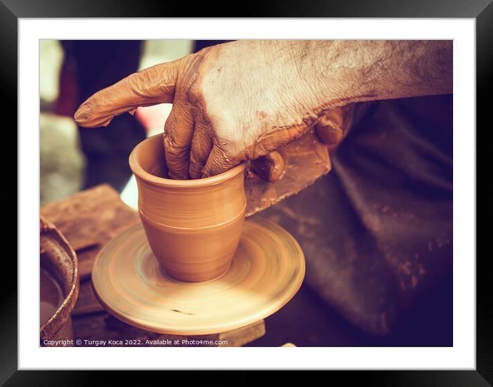 Potter`s hands shaping up the clay Framed Mounted Print by Turgay Koca