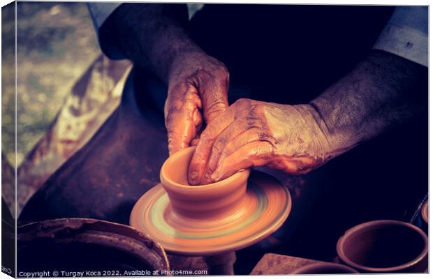 Potter`s hands shaping up the clay Canvas Print by Turgay Koca