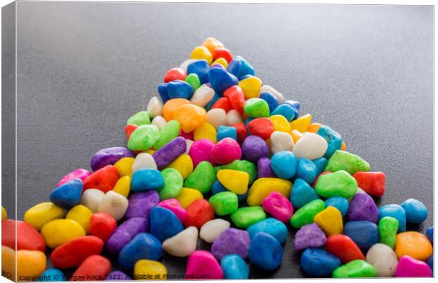 Pile of colorful pebbles as a stone background Canvas Print by Turgay Koca