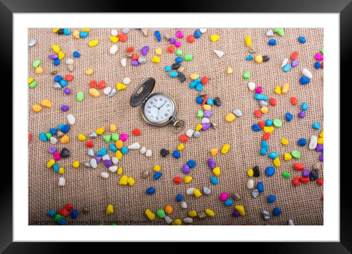 Pocket watch amid Colorful pebbles  Framed Mounted Print by Turgay Koca