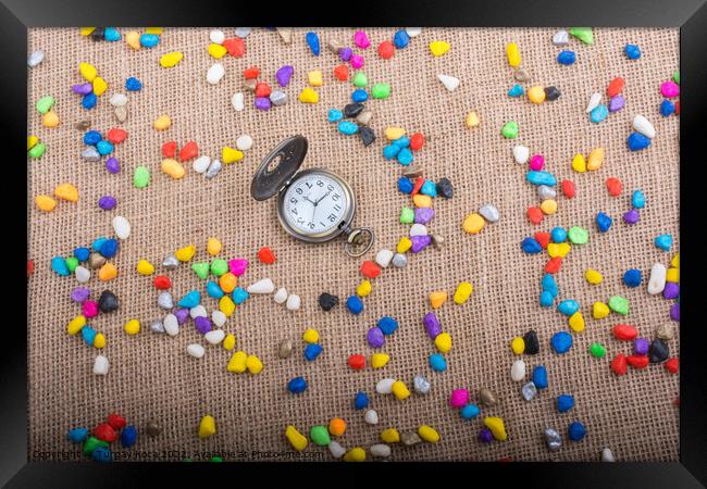 Pocket watch amid Colorful pebbles  Framed Print by Turgay Koca
