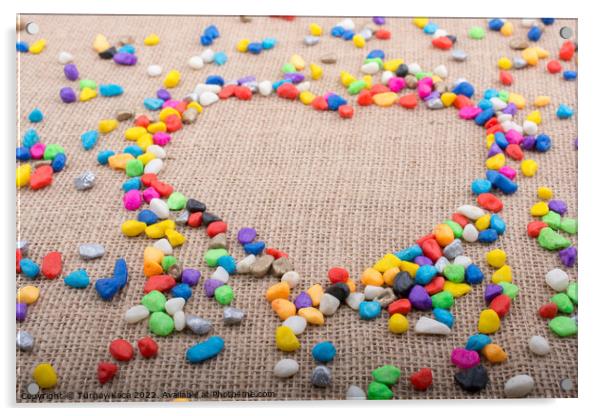 Colorful pebbles form a heart shape on canvas grou Acrylic by Turgay Koca