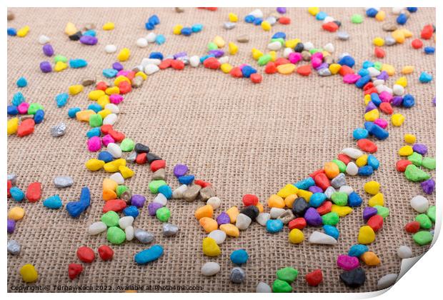 Colorful pebbles form a heart shape on canvas grou Print by Turgay Koca