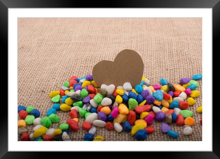 Paper heart amid pebbles on canvas ground Framed Mounted Print by Turgay Koca