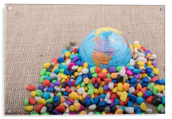 Little model globe amid colorful pebbles  Acrylic by Turgay Koca