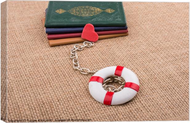 Books attached to a life saver with a chain Canvas Print by Turgay Koca