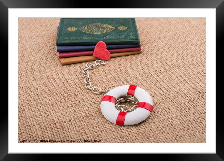 Books attached to a life saver with a chain Framed Mounted Print by Turgay Koca