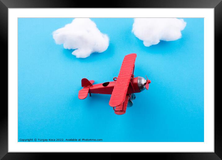 Toy airplane in sky  Framed Mounted Print by Turgay Koca