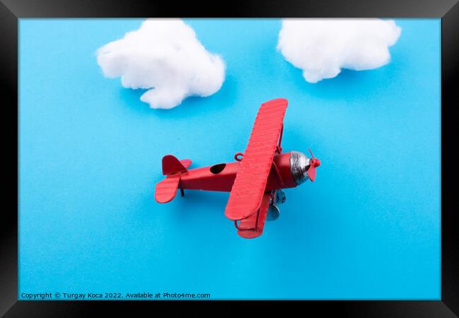 Toy airplane in sky  Framed Print by Turgay Koca