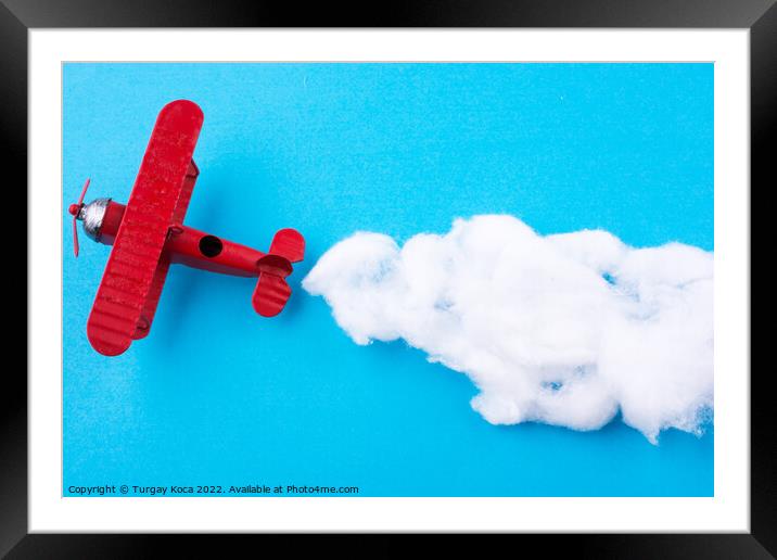 Toy airplane in sky  Framed Mounted Print by Turgay Koca