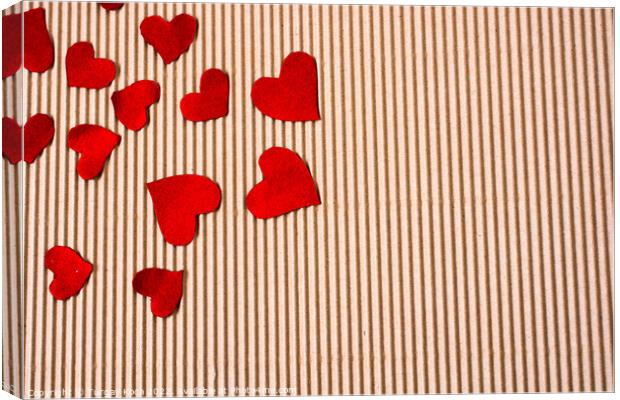 Red color paper hearts on a brown cardboard Canvas Print by Turgay Koca