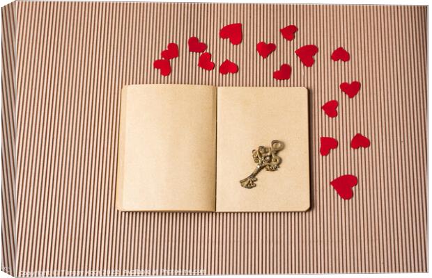 paper hearts around notebook with a retro key  Canvas Print by Turgay Koca